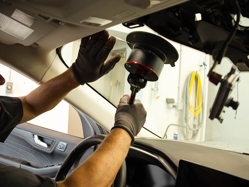 Fairway employees installing a new windshield from the inside